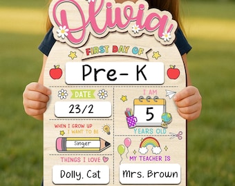 May include: A wooden sign with the name "Olivia" in pink script and daisy accents. The sign is for the first day of Pre-K and includes sections for date, age, future career, favorite things, and teacher's name.