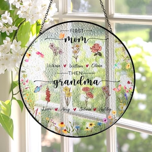 May include: Round glass suncatcher with a floral design and the text "First Mom Then Grandma" with names of children listed below.