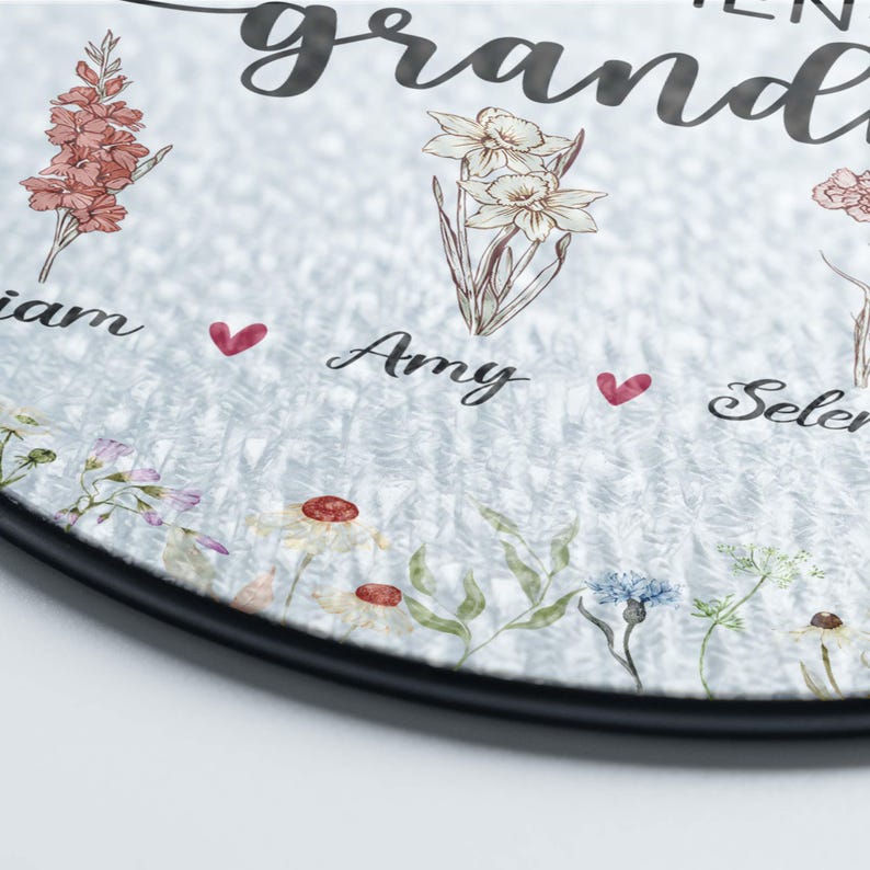 May include: A round wooden sign with the text "To my amazing grandpa" and a floral design. The names "Liam", "Amy", and "Selena" are written below the flowers.