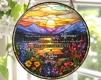 May include: Circular stained glass window art depicting a sunset over mountains and flowers. The text reads "Never underestimate the difference you've made and the lives you've touched. HAPPY RETIREMENT Sophia."