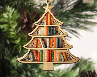 May include: Wooden Christmas tree ornament shaped like a bookshelf, filled with miniature books. The ornament has a star on top and is decorated with floral accents. A gold string is attached for hanging.