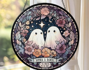 May include: Round stained glass window art featuring two friendly ghosts surrounded by flowers and foliage. The design includes a banner with the names "Sophia & Daniel" and the phrase "Til Death Do Us Part". The color palette includes shades of purple, pink, and blue.