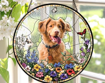 May include: Round stained glass window art featuring a golden retriever dog with its tongue out, surrounded by colorful flowers and butterflies. The window is framed in black and hangs from a chain.