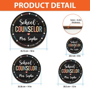 May include: Round wooden sign with the text "School Counselor" in colorful letters, with the name "Mrs. Sophie" below. The sign is black with white text and floral accents. The sign is 18 inches in diameter.