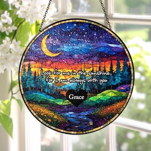May include: A circular stained glass suncatcher featuring a landscape with a crescent moon, starry night sky, pine trees, and a stream. The text reads, "Look for me in the sunshine, for I am always with you" above a black heart labeled "Grace."