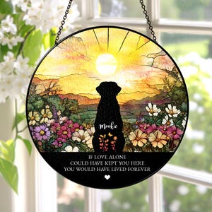 May include: Round stained glass window art featuring a black silhouette of a dog, named Mookie, overlooking a colorful floral landscape with a sunset backdrop. The text reads "If love alone could have kept you here, you would have lived forever."