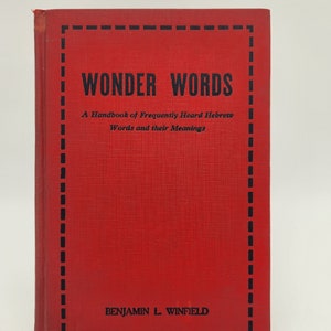 May include: A red hardback book with the title "WONDER WORDS: A Handbook of Frequently Heard Hebrew Words and their Meanings" and the author's name "BENJAMIN L. WINFIELD" printed on the cover.