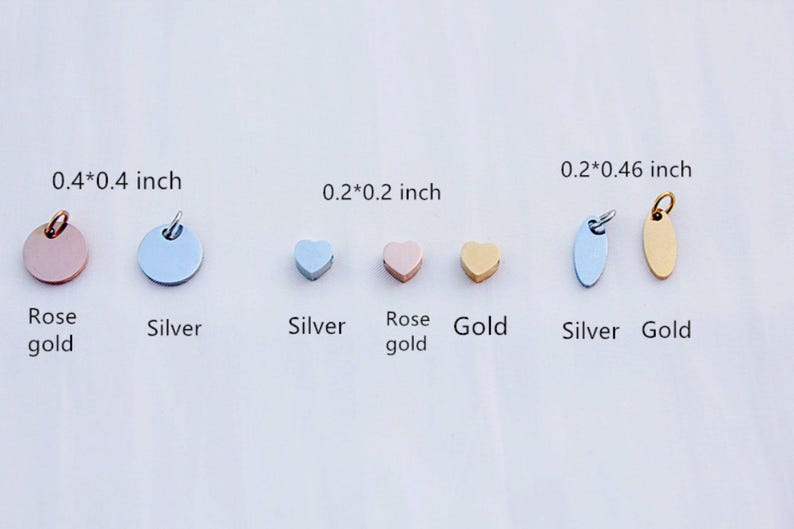 May include: A collection of small metal charms in rose gold, silver, and gold. Shapes include circles, hearts, and ovals. Sizes range from 0.2 x 0.2 inches to 0.4 x 0.4 inches. Each charm has a small loop for attaching to jewelry.