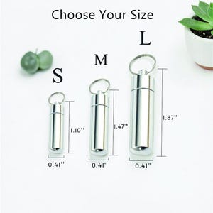 May include: Three silver-colored, cylindrical containers with keychains, labeled S, M, and L, indicating size options. Measurements are provided in inches: 1.10", 1.47", and 1.87" tall, with a consistent 0.41" diameter. The text "Choose Your Size" is at the top.