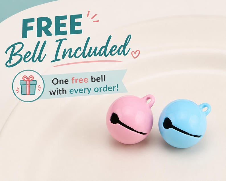 May include: Two small spherical jingle bells, one pastel pink and one light blue, each featuring a top loop and a horizontal slit. Text on the image reads: FREE Bell Included, One free bell with every order! with a small gift box icon.