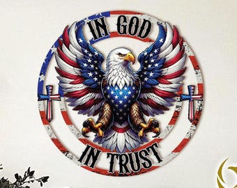 May include: A round metal wall art piece featuring an American bald eagle with outstretched wings. The eagle is set against a backdrop of the American flag colors, with the text "IN GOD" above and "IN TRUST" below.