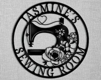 May include: Black metal sign with the text "Jasmine's Sewing Room" in a circle around a silhouette of a sewing machine with flowers.