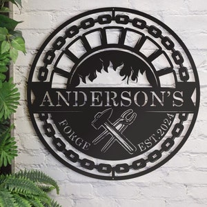 May include: Black metal sign with a circular design featuring a chain link border, flames, crossed hammer and wrench, and the text "Anderson's Forge Est. 2024".