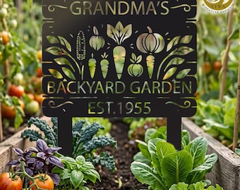 May include: Black metal garden sign with the words "GRANDMA'S BACKYARD GARDEN EST. 1955" and vegetable cutouts. The sign is in a garden bed with tomatoes and lettuce.