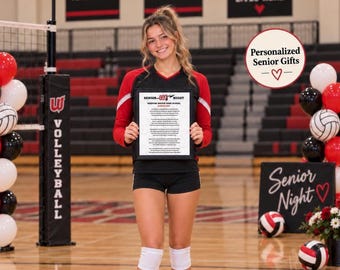May include: A black and red volleyball jersey and black shorts worn with white knee pads. The jersey features long red sleeves and a black bodice. A white sign with black text reading Senior Night Weeping Water High School is held.