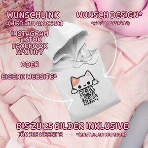 May include: White hooded sweatshirt featuring a cartoon cat design with a QR code. The sweatshirt has text in German, including "WUNSCHLINK" and "WUNSCH DESIGN". The design includes social media platform names like Instagram, TikTok, Facebook, and Spotify.
