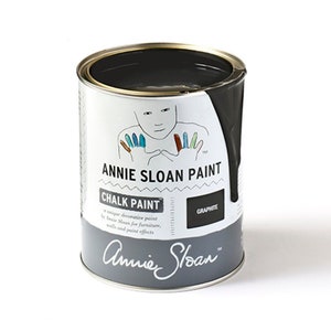 May include: A can of Annie Sloan Chalk Paint in the color Graphite. The can is white with black text and a colorful handprint design.