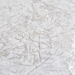 May include: White textured surface with a subtle pattern of raised lines and swirls. The surface has a slightly rough, uneven texture.