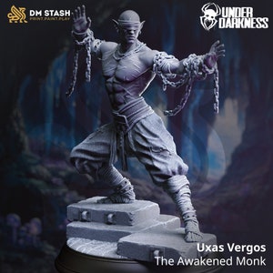 May include: A grey 3D printed miniature of a blindfolded elf monk, bound in chains, in a fighting pose. The miniature is standing on a stone platform. The text "Uxas Vergos The Awakened Monk" is printed below the miniature.