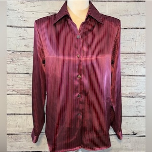 May include: A long-sleeved, burgundy striped satin blouse with a button-up front.