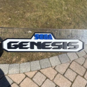 Sega Genesis Logo Sign for Wall Display, Shelf Display, or Fridge Magnet - Comes with Magnets, 4 Stands, and Double-sided tape
