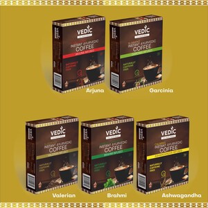 May include: Six boxes of instant Ayurvedic coffee with different herbal infusions. Each box features a brown background with gold accents and the text "VEDIC" in gold lettering. The boxes are arranged in two rows of three. The top row features Arjuna, Garcinia, and the bottom row features Valerian, Brahmi, and Ashwagandha.