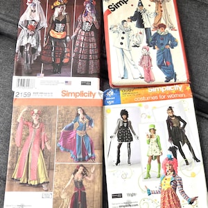 May include: Four Simplicity sewing pattern envelopes featuring various costume designs, including skeleton-themed outfits, clown suits, historical-style dresses, and colorful patterned ensembles with printed text and barcodes on the front covers.