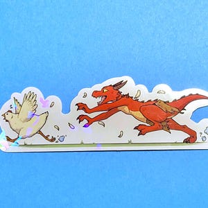 May include: A sticker featuring a cartoon dragon chasing a chicken. The dragon is red with brown accents, and the chicken is white. The sticker has a holographic effect and is set against a blue background.