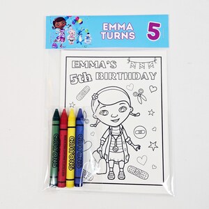 May include: A clear plastic bag contains a coloring book and crayons. The coloring book features a cartoon character and the text "EMMA'S 5th BIRTHDAY". Four crayons in green, red, yellow, and blue are included.