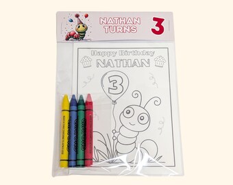 May include: A clear plastic package containing a coloring sheet and four crayons. The sheet features a cartoon caterpillar, a balloon with the number 3, and the text Happy Birthday NATHAN. The header card reads NATHAN TURNS 3.