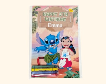 May include: A clear plastic package containing a coloring activity set featuring Stitch and Lilo on a beach background. The text reads HAPPY 5TH BIRTHDAY Emma. Four crayons in green, yellow, blue, and red are included at the bottom of the package.
