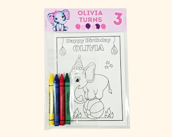 May include: A clear plastic package containing a coloring sheet and four crayons. The header features a cartoon elephant and the text OLIVIA TURNS 3. The coloring sheet displays an elephant on a ball with the text Happy Birthday OLIVIA.