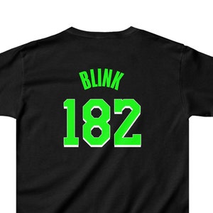 May include: Black t-shirt with a green "Blink 182" graphic on the back.