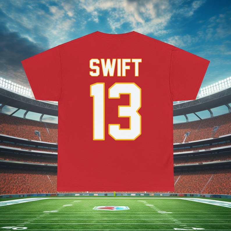 May include: Red t-shirt with the name "SWIFT" and the number "13" printed on the back in white with a yellow outline.