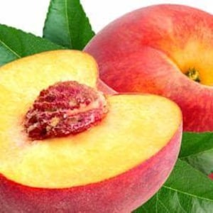 May include: A whole peach and a peach cut in half are displayed, showcasing a rich red and yellow hue. The cut peach reveals a textured stone. Green leaves are arranged around the fruit, creating a fresh, natural composition.