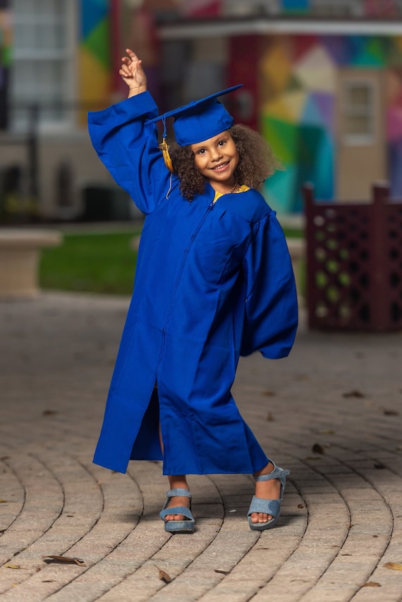 Premium Photo | Indonesian children wearing gown standing and smiling at  camera nursery school graduation