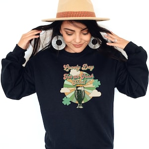 May include: Black sweatshirt with a retro-style graphic of a pint of beer and the text "Lovely Day for an Irish Stout".