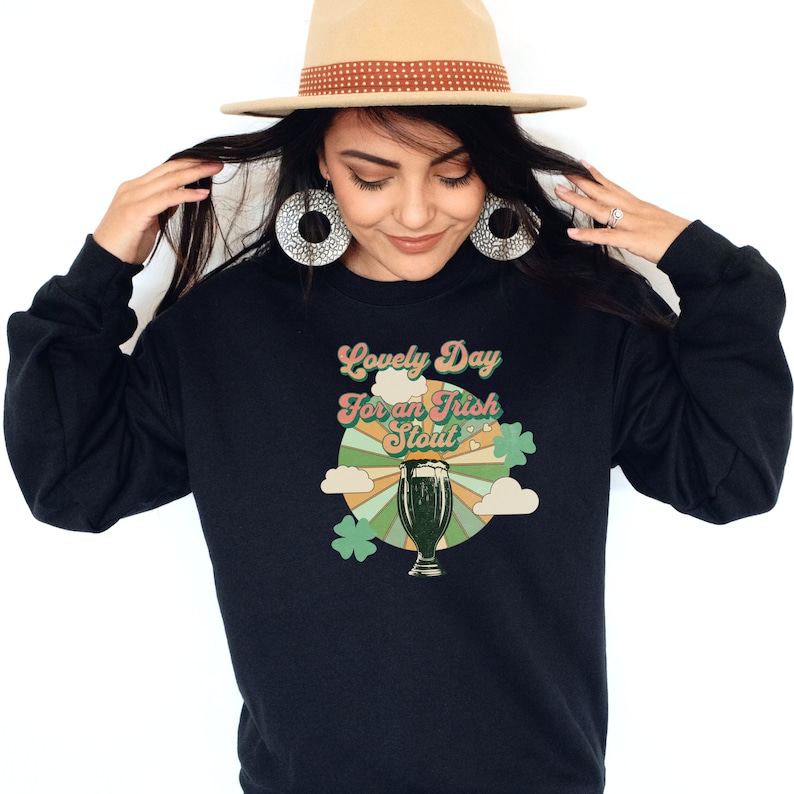 May include: Black sweatshirt with a retro-style graphic of a pint of beer and the text "Lovely Day for an Irish Stout".
