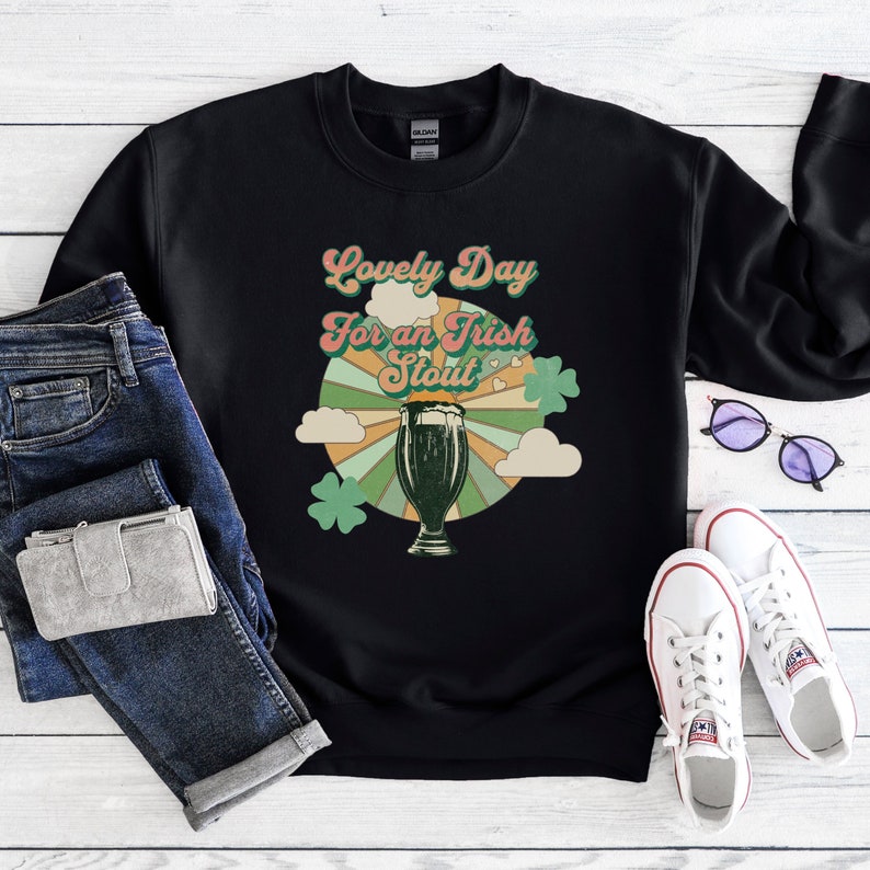 May include: Black sweatshirt with a retro-style graphic of a glass of stout beer and the text "Lovely Day for an Irish Stout".