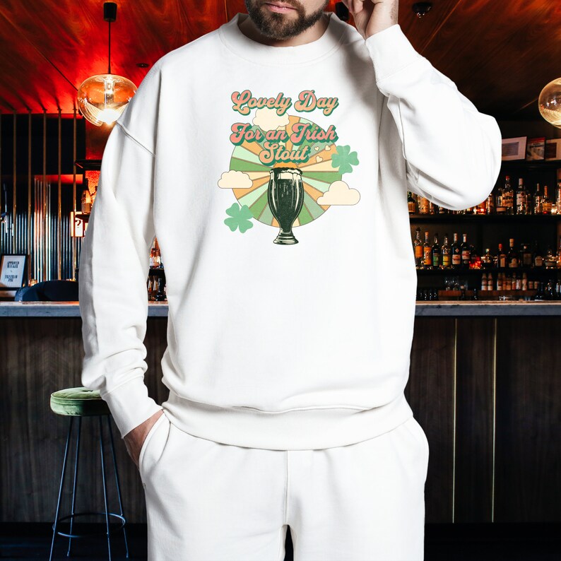 May include: White sweatshirt with a retro-style graphic of a pint of beer and the text "Lovely Day For an Irish Stout".