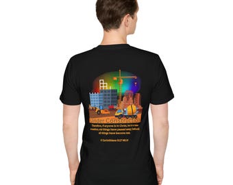 May include: Black t-shirt with a graphic of a construction site with a crane, buildings, and construction vehicles. The text "Under Construction" is printed on the shirt, along with the Bible verse "Therefore, if anyone is in Christ, he is a new creation; old things have passed away; behold, all things have become new. 2 Corinthians 5:17 NKJV."