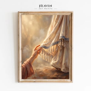 May include: A framed art print titled Heaven Art Prints featuring a hand reaching towards a draped, cream-coloured fabric with a blue-trimmed edge and hanging tassels. The scene is set against a soft, glowing, golden-hued background with light.