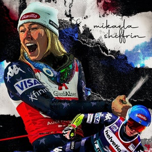 May include: Mikaela Shiffrin, a professional skier, wearing a red, white, and blue ski suit with the words "Visa", "Xfinity", and "GlasfAlser" on it. She is holding a ski pole and is in mid-air, with a spray of snow behind her. The text "World Cup Win Record Holder" is at the bottom of the image.