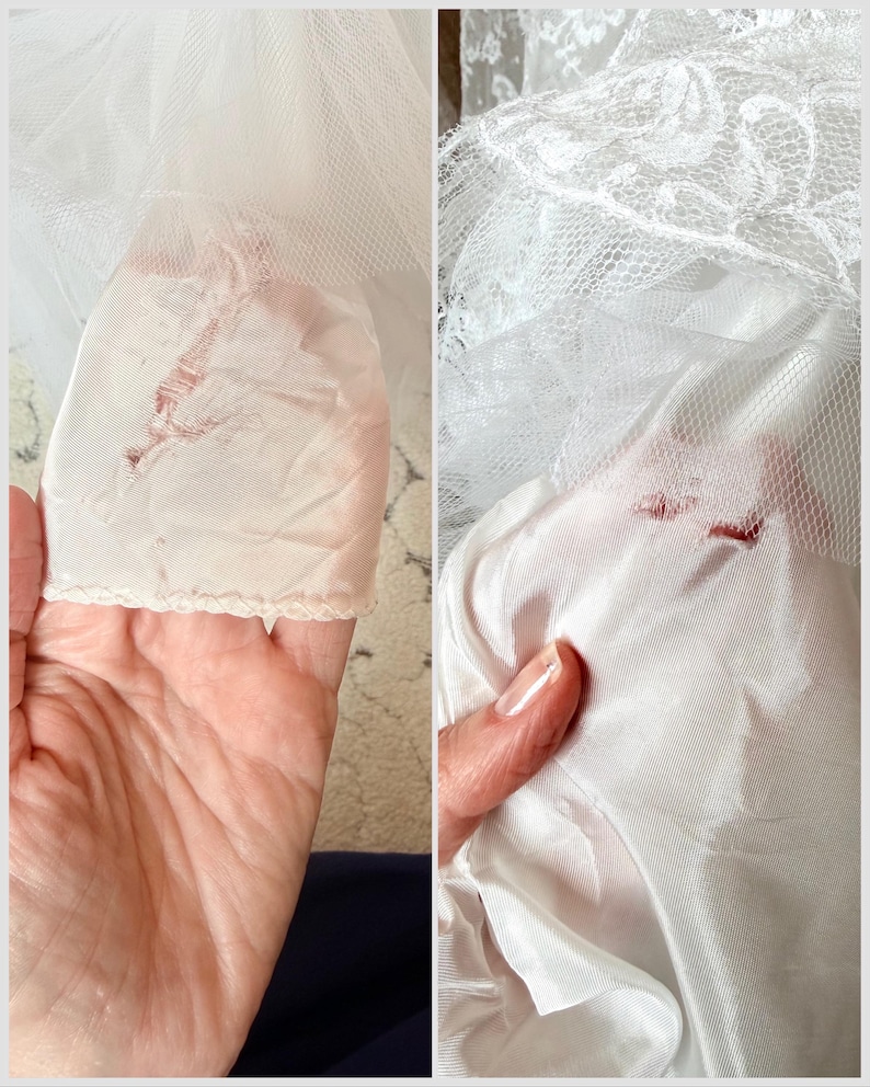 May include: A white garment featuring layers of sheer tulle fabric and a smooth, opaque lining. The fabric displays visible signs of wear, including small tears and frayed areas in the delicate netting and the underlying satin-like material.