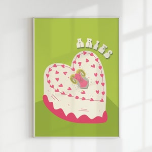 May include: A green background with a white heart-shaped cake decorated with pink hearts. The cake has a pink ram in the center with gold horns. The text "ARIES" is in a retro font at the top of the image.