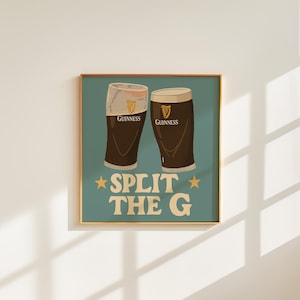 May include: A framed print featuring two pints of Guinness stout. The image has a teal background with the words "SPLIT THE G" in large, white letters. The Guinness logo is visible on each glass.