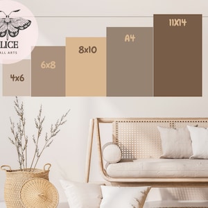 May include: A white wall with a brown, beige, and gray color palette.  The wall displays different sizes of prints, including 4x6, 6x8, 8x10, A4, and 11x14.  The prints are arranged in a staggered pattern, with the largest print at the top and the smallest print at the bottom.  The prints are all framed in a simple, black frame.