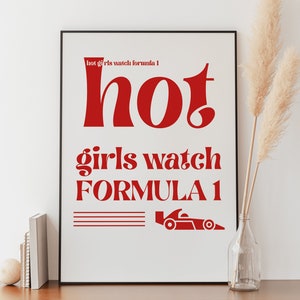 May include: A white framed poster with red text that reads "hot girls watch formula 1" and a red silhouette of a racing car.