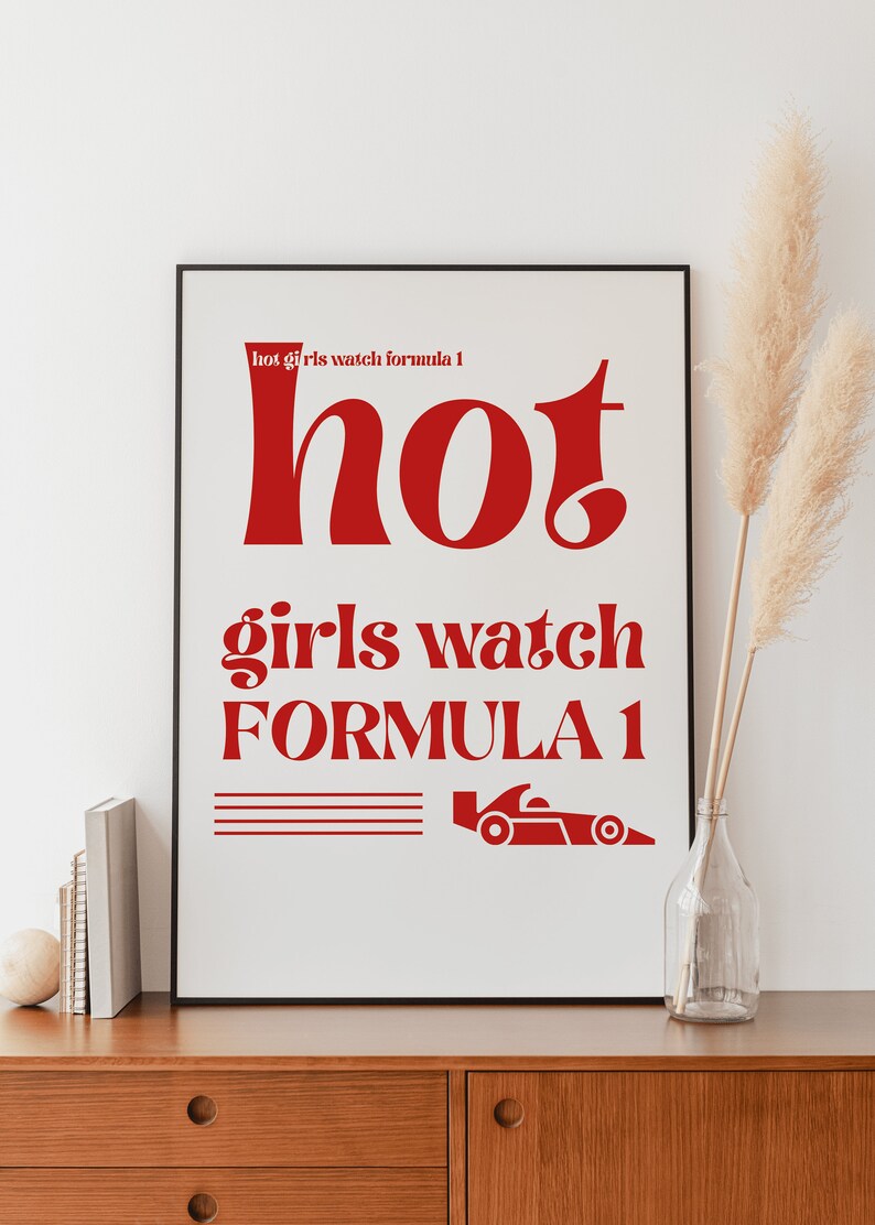 May include: A white framed poster with red text that reads "hot girls watch formula 1" and a red silhouette of a racing car.