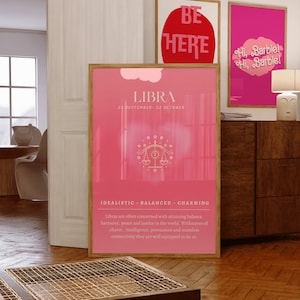 May include: A pink and white poster with the zodiac sign Libra. The poster has the text "LIBRA" in white with the dates "23 SEPTEMBER - 22 OCTOBER" below. The poster also has a stylized image of a scale with stars and a sun. The text "IDEALISTIC - BALANCED - CHARMING" is below the image. The poster has a description of the Libra zodiac sign.